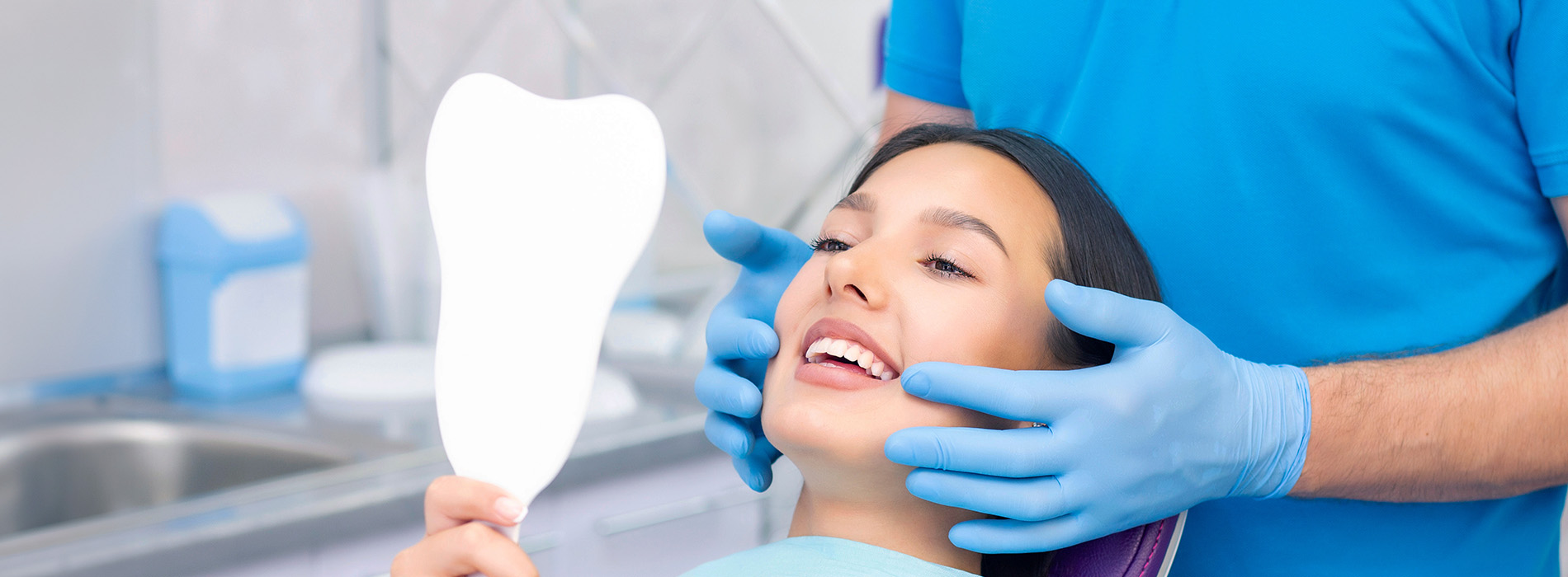 A dental hygienist assisting a patient with a dental examination.